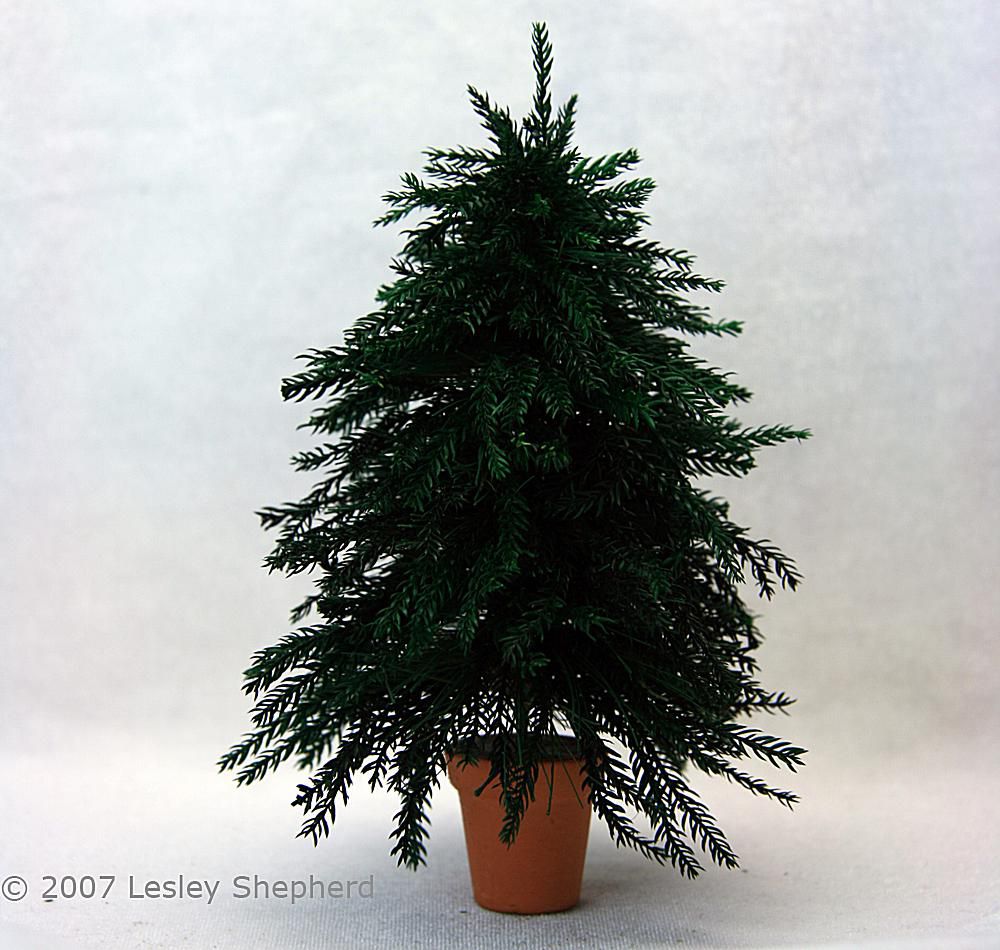 Six inch high miniature Christmas tree with realistic branches.