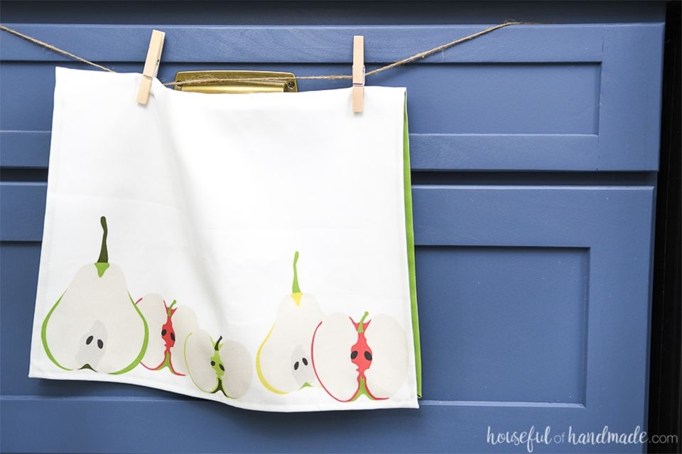 A tea towel hanging by clothespins