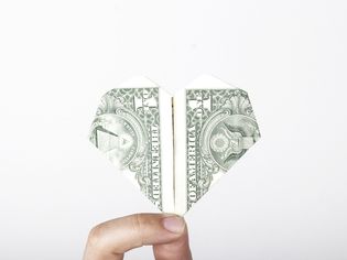 an origami heart made from a dollar