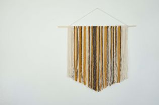 Wall hanging on a white wall.