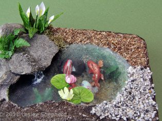 Range of materials used to landscape a dolls house scale fish pond