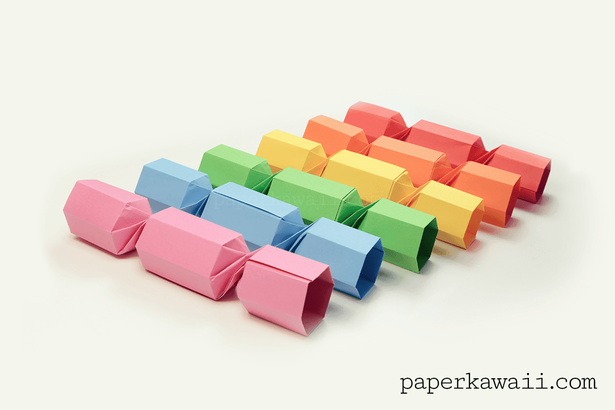 Six origami Christmas cracker holders in rainbow colors.