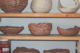 Pottery drying on shelves, showing placement for good air circulation.