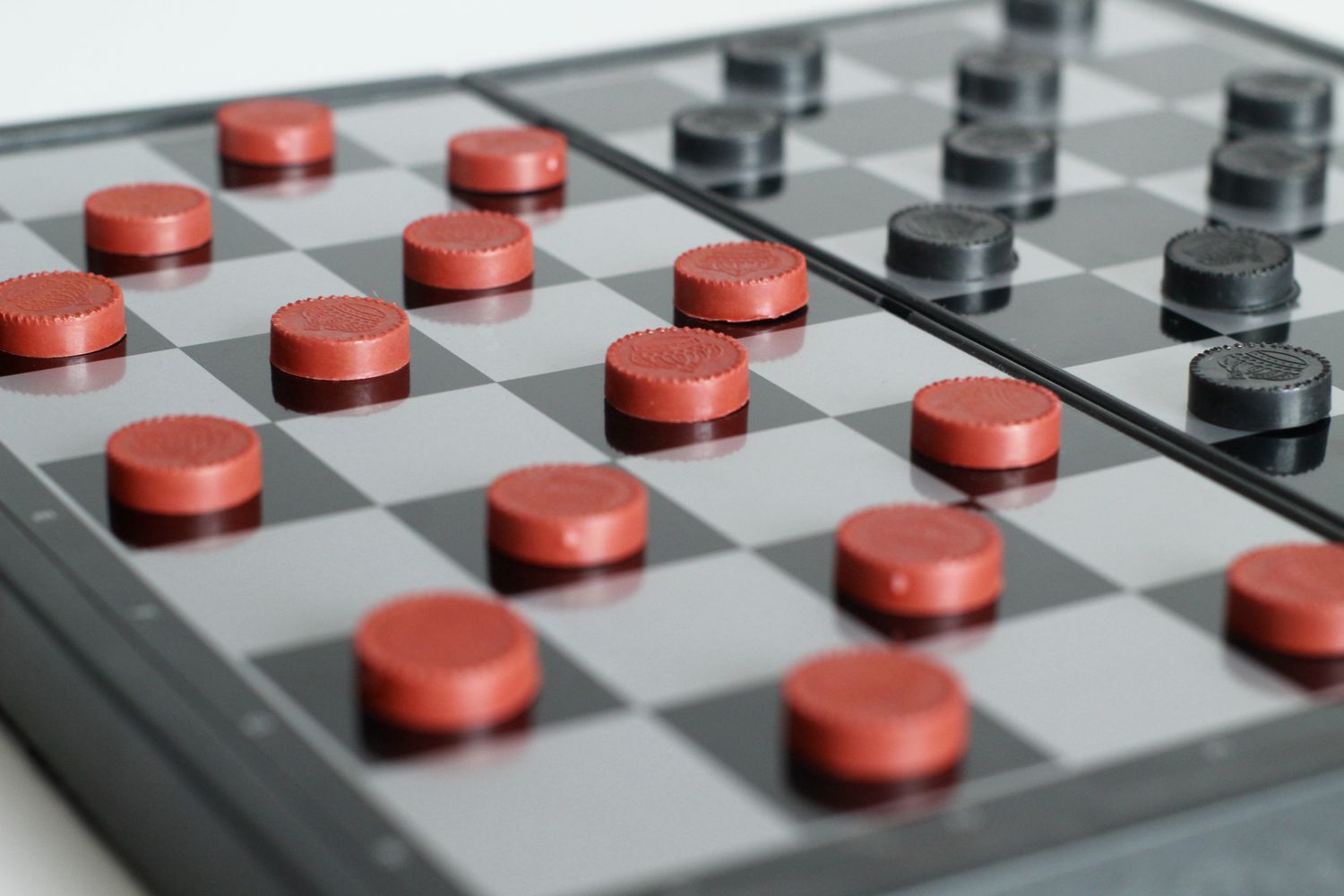 Close-Up Of Checkers Over White Background